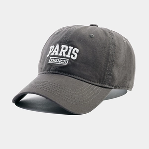 Close-up of premium dark grey cotton baseball cap with white 3D embroidery detail