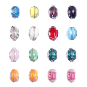 Macro view of sixteen colorful glass beads with floral patterns for DIY bracelets