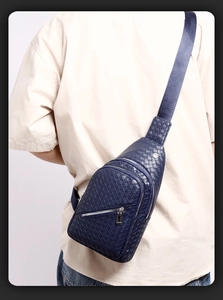 Navy blue woven PU leather chest bag worn by male model from a back perspective view