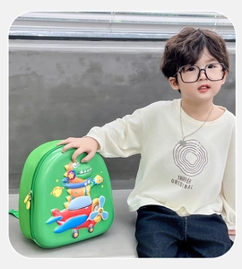 Détail du sac à dos dinosaure 3D vert pour enfants avec un jeune mannequin garçon