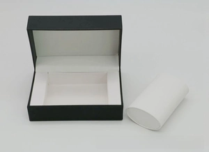 Detail view of a black PU leather watch box with white cushion for jewelry storage