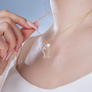 Close-up of S925 silver necklace with golden fish pendant and white zircon inlay