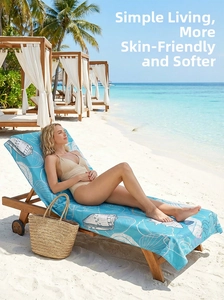 Detail of soft microfiber beach towel with shell prints on a wooden sun lounger