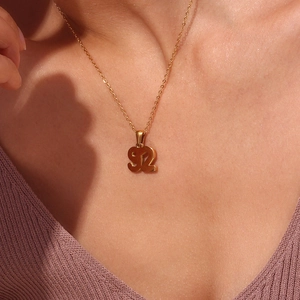Close-up of model wearing 18K gold plated necklace with number 92 pendant