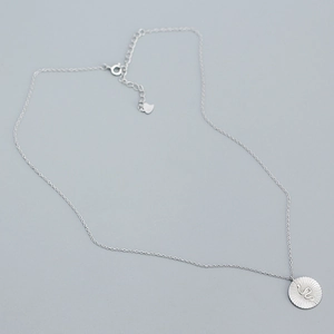 Detailed view of silver snake pendant and dainty chain necklace with lobster clasp