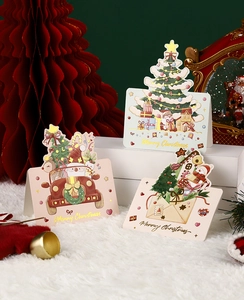 Three festive Christmas gift cards featuring Santa and snowmen on a holiday display stand
