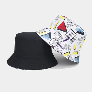 Detail of reversible bucket hat in black and colorful 3D geometric patterns on canvas fabric