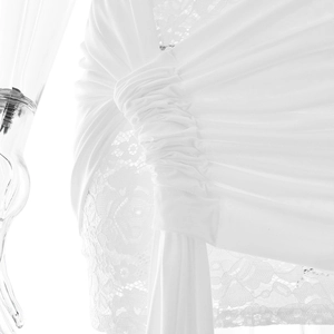 Detailed view of white lace hollow-out fabric and draped pleats on this sexy mini dress
