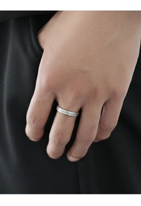 Close-up of vintage silver men's ring with textured surface on model finger