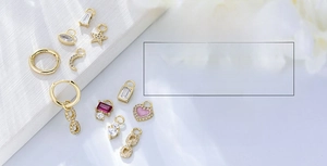 Detailed view of 925 silver gold-plated hoop earrings with star moon and zircon charms