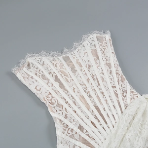 Close-up of intricate white lace detail and corset boning structure on a mini dress