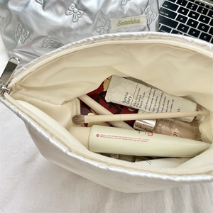 Close-up of quilted PU heart cosmetic bag showing spacious interior for skincare storage