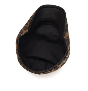 Detail view of leopard print newsboy cap showing internal black lining and stitching