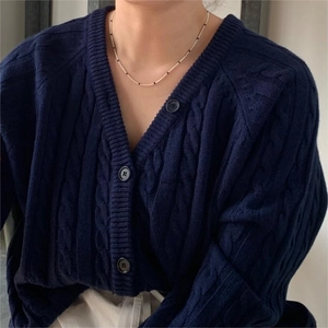 Navy blue V-neck cable knit cardigan with buttons and beaded necklace detail