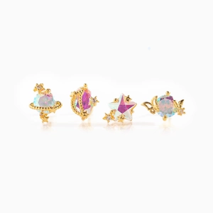 Detailed macro shot of 18K gold-plated star, moon, and planet earring set with opal stones
