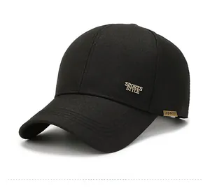 Side view detail of black baseball cap showing gold metal sports plate and fabric texture