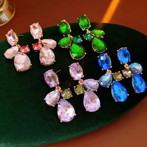 Detailed view of vintage gold-tone earrings featuring colorful teardrop-shaped gemstones