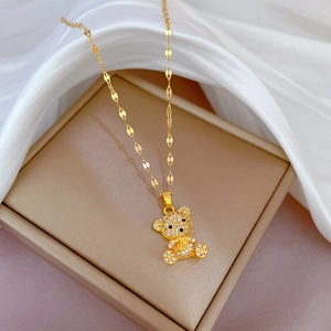 Titanium steel teddy bear necklace with clear micro-pave crystals on beige jewelry box