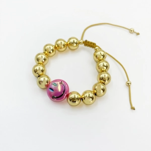 Detail of 18k gold-plated beaded bracelet with gradient smiley face and adjustable cord
