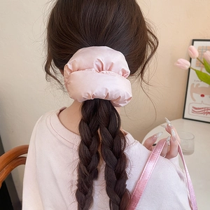 Detailed back view of a pink satin oversized scrunchie styled in hair with a soft shine