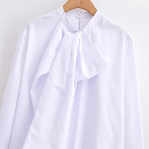 Elegant white long-sleeve blouse for women featuring a large bow tie neck design