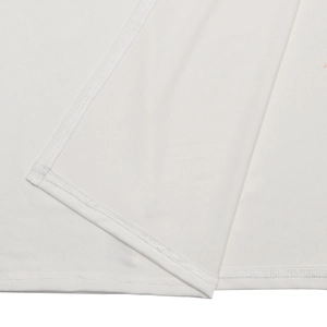 Detail of the high-slit hem showing fine stitching on a white sleeveless maxi dress