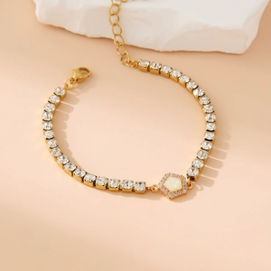 Elegant gold-tone stainless steel bracelet featuring hexagonal pendant and clear crystals
