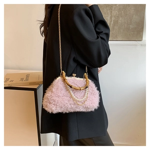 Detail of pink faux fur bag featuring bamboo handle and elegant pearl fringe charms