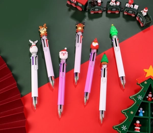 Close-up of multicolor Christmas pens with Santa, reindeer, and snowman silicone toppers