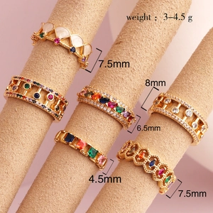 Detailed close-up of gold geometric rings with colored zircon and various width measurements