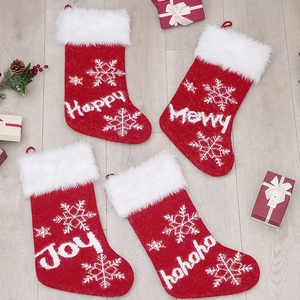 Set of four red knitted Christmas stockings with snowflake patterns and white faux fur trim