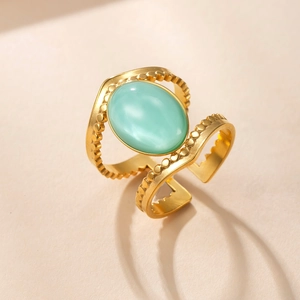 Detailed close-up of golden vintage double-line ring with oval turquoise stone