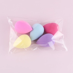 Five assorted colors of teardrop-shaped non-latex beauty sponges in transparent packaging