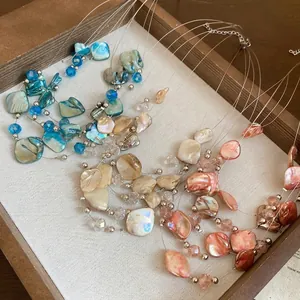 Multilayer shell bead necklace in blue, amber and pink for beach vacation style