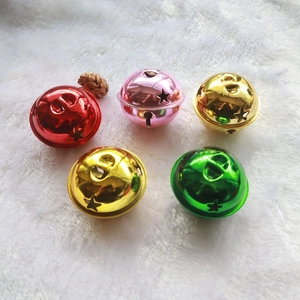 5cm star hollowed metal Christmas bells in red, pink, gold and green on white plush