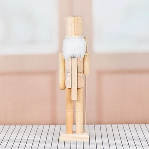 Rear view of 38cm unfinished wooden nutcracker puppet with white beard on checkered cloth