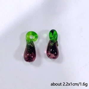 Macro detail of two purple glass eggplant pendants with dimensions 2.2x1cm and 1.6g weight