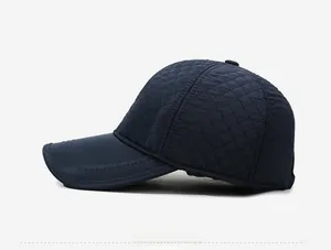 Side view of navy blue quilted baseball cap with warm diamond stitched padding texture