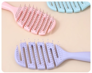 Flat lay macro of pink, purple, and blue vented hairbrushes with fine metal bristles