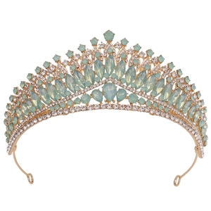 Detailed view of bridal crown with mint green crystals and golden alloy setting