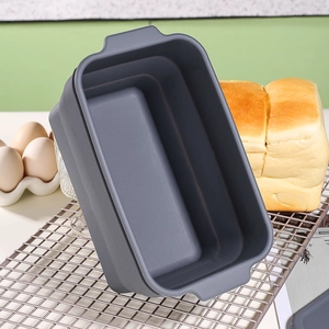 Collapsible grey silicone bread loaf pan for baking in professional kitchen setting