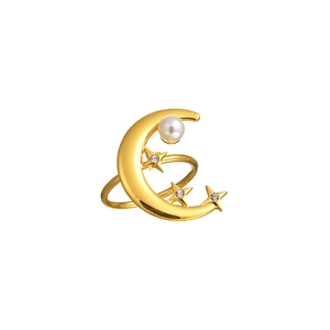 Detailed view of gold moon napkin ring with pearl and sparkling star gemstone accents