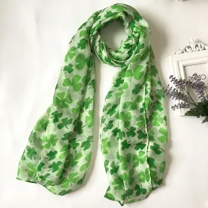 Lightweight St. Patrick's Day scarf with green shamrock prints on white fabric