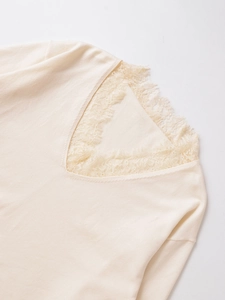 Detailed view of V-neck wool blend knit sweater with delicate eyelash lace trim