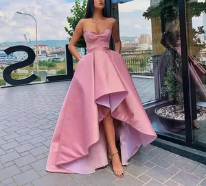 Detailed view of pink satin high-low hemline evening dress with strapless neckline design