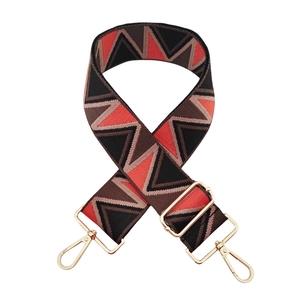 Detail of geometric triangle jacquard woven wide strap with gold metal swivel hooks