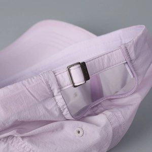 Detail of light purple baseball cap featuring metal buckle and breathable ripstop fabric