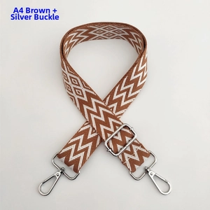 Detail of A4 brown and white geometric wave shoulder strap with silver metal buckles