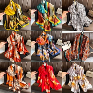 Collage of floral silk scarves in various patterns including roses and paisley prints