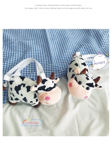 Detail of cute cow plush crossbody bags with black white spots and soft woven straps